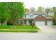 Charming two-story home featuring a well-manicured lawn, brick accents, and an attached two-car garage at 8727 Redditch Dr, Avon, IN 46123