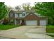 Charming two-story home featuring a well-manicured lawn, brick accents, and an attached two-car garage at 8727 Redditch Dr, Avon, IN 46123