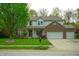 Charming two-story home featuring a well-manicured lawn, brick accents, and an attached two-car garage at 8727 Redditch Dr, Avon, IN 46123