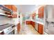 This modern kitchen features wood cabinets, stainless appliances and stone countertops at 8727 Redditch Dr, Avon, IN 46123