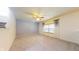 Spacious living room featuring plush carpet, a large window, and a ceiling fan at 8727 Redditch Dr, Avon, IN 46123