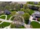 Aerial view showcasing the lush neighborhood with mature trees, long driveway, and well-kept homes at 923 Woodcrest Way, Anderson, IN 46012