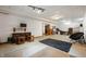 Open basement area with TV, comfortable chair, neutral walls and carpet at 923 Woodcrest Way, Anderson, IN 46012