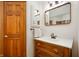 Charming bathroom features a carved wood vanity, decorative mirror and stylish faucet at 923 Woodcrest Way, Anderson, IN 46012