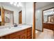 Well-lit bathroom with a granite countertop, wood cabinets, and multiple doorways at 923 Woodcrest Way, Anderson, IN 46012