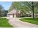 Spacious home boasts an attached garage, beautiful landscaping, and a curved driveway at 923 Woodcrest Way, Anderson, IN 46012