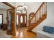 Inviting foyer featuring hardwood floors, staircase, and chandelier at 923 Woodcrest Way, Anderson, IN 46012