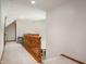 Bright hallway with carpeted floors and wooden railing overlooking a comfortable living area at 923 Woodcrest Way, Anderson, IN 46012