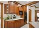 Warm wood cabinets and white countertops offer style and function in this well-equipped kitchen at 923 Woodcrest Way, Anderson, IN 46012