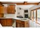 Open concept kitchen featuring stainless steel appliances, a central island, and view into the living area at 923 Woodcrest Way, Anderson, IN 46012