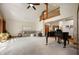 Open living room area with high ceilings, piano, and comfortable seating arrangement at 923 Woodcrest Way, Anderson, IN 46012