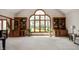 Bright living room with large windows, built-in shelving, and neutral carpeting at 923 Woodcrest Way, Anderson, IN 46012