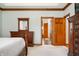 Main bedroom with ensuite bathroom and elegant wood furniture at 923 Woodcrest Way, Anderson, IN 46012