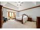 Spacious main bedroom with tray ceiling, large window and carpet floors at 923 Woodcrest Way, Anderson, IN 46012