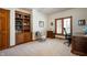 Bright office with built-in wooden bookcase, neutral walls, carpet and a wooden window providing natural light at 923 Woodcrest Way, Anderson, IN 46012