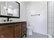 Modern bathroom with a wood vanity, black fixtures, and patterned tile floors and a glass shower at 9417 Glencroft Way, Indianapolis, IN 46250