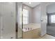 Bathroom featuring a separate shower and a large tub with tile surround at 9417 Glencroft Way, Indianapolis, IN 46250