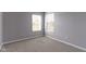 A carpeted bedroom featuring two windows at 9417 Glencroft Way, Indianapolis, IN 46250