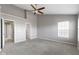 A spacious bedroom with a ceiling fan, neutral walls, and two doorways at 9417 Glencroft Way, Indianapolis, IN 46250