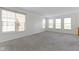 Bright bonus room with neutral walls, plush gray carpet, and two large windows with views at 9417 Glencroft Way, Indianapolis, IN 46250