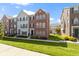Attractive brick townhome featuring manicured lawn, blue shutters, and a welcoming entrance at 9417 Glencroft Way, Indianapolis, IN 46250