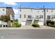 Townhome featuring attached garages, second-story balconies, and manicured landscaping at 9417 Glencroft Way, Indianapolis, IN 46250