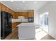 Kitchen with white countertops, wood cabinetry, stainless appliances and a sliding door leading to the yard at 9417 Glencroft Way, Indianapolis, IN 46250