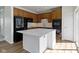 Updated kitchen features a large center island, modern appliances, and wood cabinets at 9417 Glencroft Way, Indianapolis, IN 46250