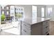 Stylish kitchen island with white cabinets and a quartz countertop, bathed in natural light at 9417 Glencroft Way, Indianapolis, IN 46250