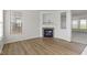Bright living room with hardwood floors and a fireplace, offering a warm and inviting space at 9417 Glencroft Way, Indianapolis, IN 46250