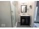 Modern bathroom with glass-enclosed shower, dark vanity, and contemporary fixtures at 949 Harrison St, Indianapolis, IN 46202