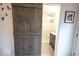 Bathroom showcasing a sliding barn door that leads to a modern shower with glass doors at 949 Harrison St, Indianapolis, IN 46202