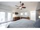 Bright bedroom with a ceiling fan, wood furniture, and French doors leading to the outside at 949 Harrison St, Indianapolis, IN 46202