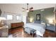 This bedroom features a wood floor, ceiling fan, and natural light at 949 Harrison St, Indianapolis, IN 46202