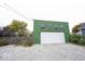 A green detached garage with a white door at 949 Harrison St, Indianapolis, IN 46202