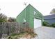 A green detached garage with a gravel driveway at 949 Harrison St, Indianapolis, IN 46202