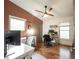 Home office setup with hardwood floors, a ceiling fan, large window, and dual desks at 949 Harrison St, Indianapolis, IN 46202
