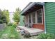 Relaxing covered porch with seating and views of the landscaped yard of this charming home at 949 Harrison St, Indianapolis, IN 46202