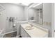 Well-lit bathroom featuring a large mirror, neutral-toned vanity, and a shower/tub combo at 9553 Maple Way, Indianapolis, IN 46268