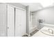 This bathroom features a white vanity, white shower/tub, and a double-door closet at 9553 Maple Way, Indianapolis, IN 46268