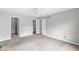 This bedroom has neutral walls, plush carpeting, and multiple doorways at 9553 Maple Way, Indianapolis, IN 46268