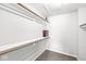 This walk-in closet features a carpeted floor and multiple shelving areas at 9553 Maple Way, Indianapolis, IN 46268