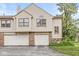 Charming townhouse featuring a two-car garage, neutral siding and a well-maintained brick facade at 9553 Maple Way, Indianapolis, IN 46268