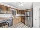 Eat-in kitchen with wood cabinets, stainless steel refrigerator and a ceiling fan at 9553 Maple Way, Indianapolis, IN 46268