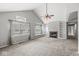 Bright and airy living room with vaulted ceiling, fireplace and built-in shelves at 9553 Maple Way, Indianapolis, IN 46268
