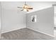 This is a carpeted living room with a ceiling fan and an open window to the kitchen at 9553 Maple Way, Indianapolis, IN 46268