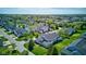 Aerial view of a peaceful neighborhood with charming homes surrounding a tranquil pond and lush green spaces at 9602 Sweet Clover Way, Fishers, IN 46038