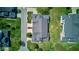 Overhead view revealing the layout of a home with backyard, highlighting the roofline, driveway, and surrounding landscaping at 9602 Sweet Clover Way, Fishers, IN 46038