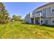 A spacious backyard featuring a well-maintained lawn and a charming two-story home with a deck at 9602 Sweet Clover Way, Fishers, IN 46038