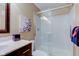 Bathroom featuring a glass shower with white subway tile and a dark wood vanity at 9602 Sweet Clover Way, Fishers, IN 46038